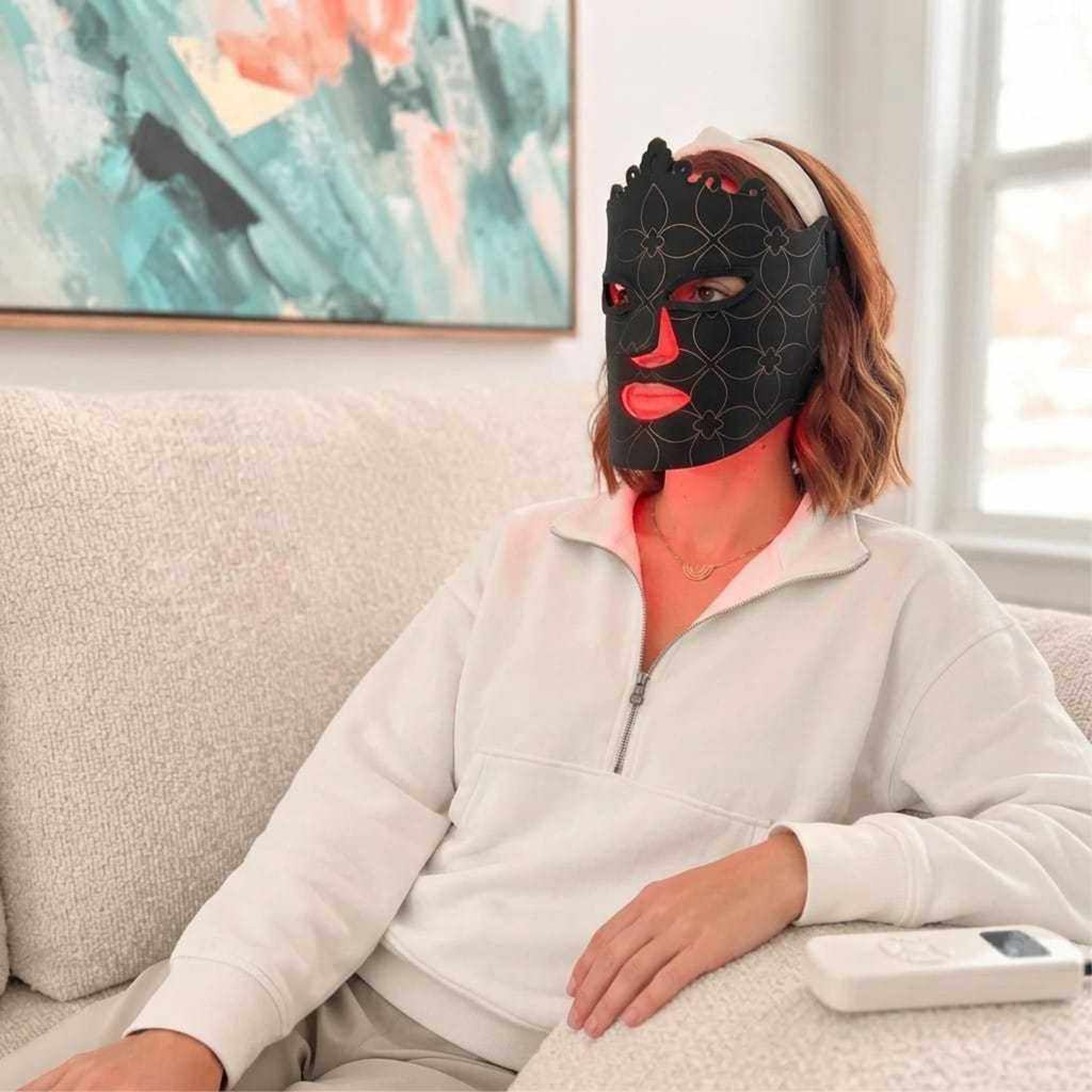 Pro Light Thera™ Mask, black flexible silicone LED face mask with a subtle circular pattern and red glowing eye, nose and mouth panels.