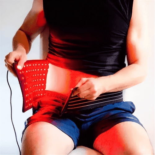 Red Light Thera™ Belt with a flexible black LED panel glowing red, perforated surface and adjustable waist strap